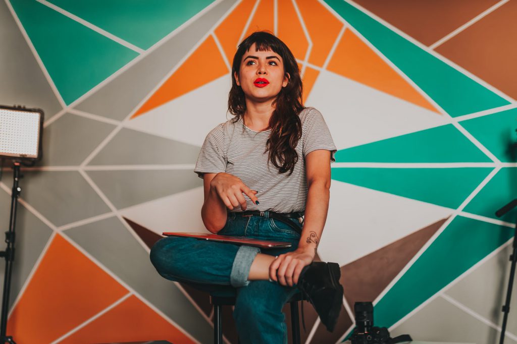 trendy young woman recording video in modern studio