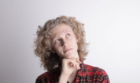 pensive male teen on gray background