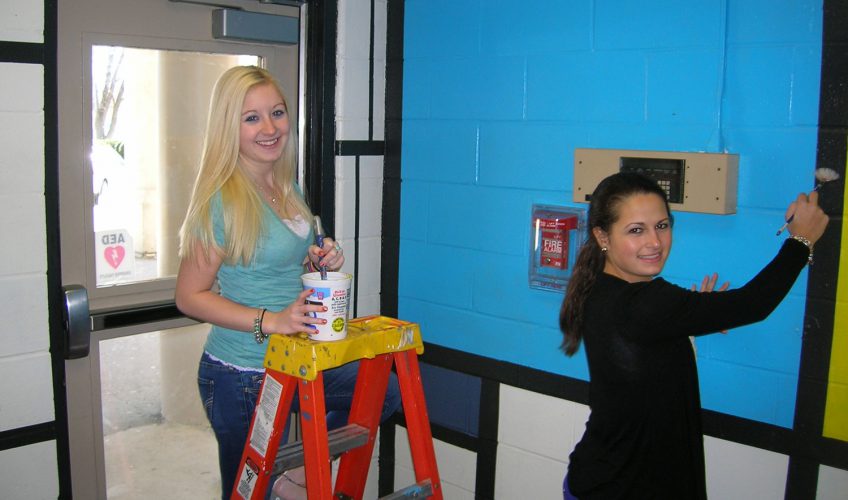 Students paint main lobby in Mondrian style.